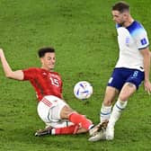 VERSATILE: New Leeds United recruit Ethan Ampadu, left, pictured in action for Wales challenging England's Jordan Henderson in November's World Cup clash against the Three Lions in Doha on. Photo by JAVIER SORIANO/AFP via Getty Images.