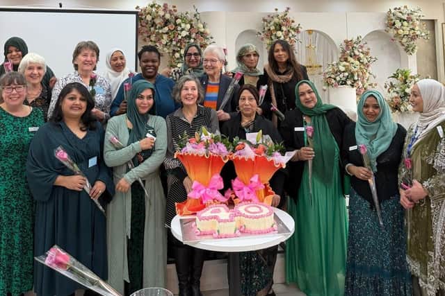 Asha staff and trustees celebrate 40 years’ service to the community with roses.