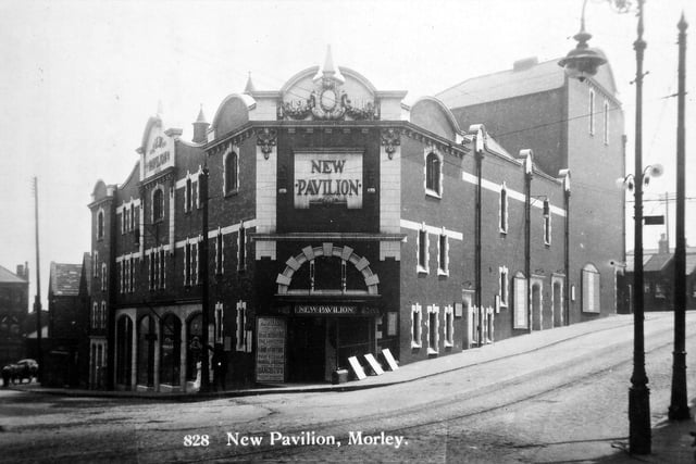 New Pavilion Theatre on South Queen Street.  From the poster outside the New Pavilion it is possible to tell that this photograph was taken during the week of June 29, 1914. This was at the time when variety items were being put on stage twice nightly. Acts advertised for that week are the Three Musical Shafers, the Four Dancistos, Bob Fame and Harry Fortune, Violet Gerald and the Lorettes. According to the Morley Observer the Three Musical Shafers, two ladies and a gentleman, are very clever comedy musicians. One of the lady performers plays a cornet admirably. The Four Dancistos are vocalists and speciality dancers of exceptional merit and both Bob Fame and Harry Fortune are very amusing versatile comedians. Miss Violet Gerald sings some excellent chorus songs among them being "Homeland" and the Lorettes give a daring act on the double trapeze.