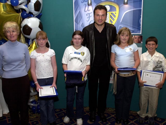 Pupils and staff from Beeston St Anthony's School receive their "Playing for Success" awards from Leeds United striker Mark Viduka in September 2002.