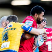 Ash Handley tackles Kallum Watkins during Leeds Rhinos' win at Salford Red Devils in February. Watkins won;t play for either club in the rematch. Picture by Allan McKenzie/SWpix.com.