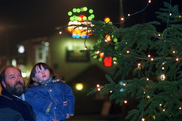 The village of Towton boasted more than 2,000 Christmas lights in December 1996 for a population of just 200. Lights organiser and resident Don Copley is pictured with young visitor Charlotte Pratt.