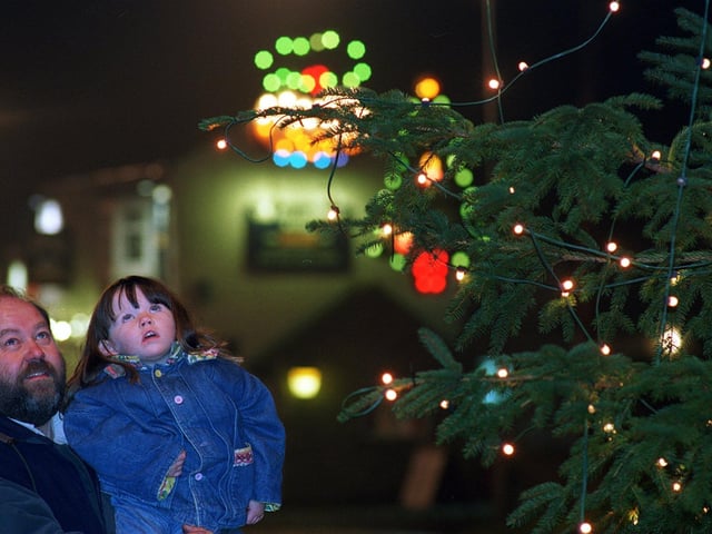 The village of Towton boasted more than 2,000 Christmas lights in December 1996 for a population of just 200. Lights organiser and resident Don Copley is pictured with young visitor Charlotte Pratt.