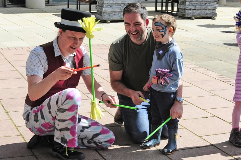 Ross Burton of Circus Leeds shows off his skills to Jonathan Murphy and son James, three, of Rothwell. (Pic by Steve Riding)