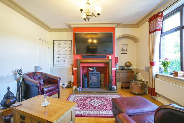 Downstairs, a spacious lounge is fitted with a feature fireplace and a log burner.