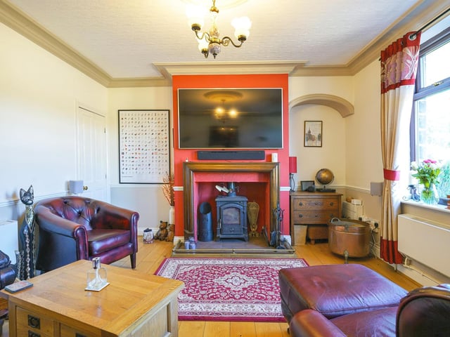 Downstairs, a spacious lounge is fitted with a feature fireplace and a log burner.