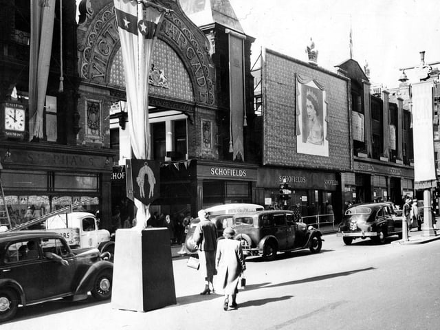 Coronation decorations on The Headrow, and entrance to the Victoria Arcade, which intersected Schofield's department store.