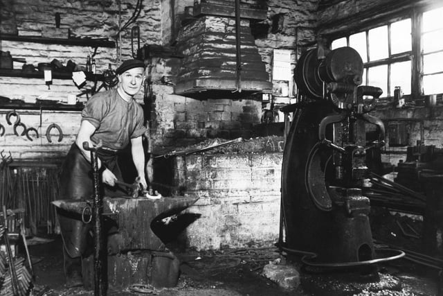 Laisterdyke blacksmith Joseph Gatenby, at work in his forge in March 1960.  "I'm still learning after 50 years in the job," said Mr Gatenby. When he entered the profession in 1914 business was booming. Textile mills, breweries, tradesmen and the railways all used horses. Then, as motorised transport came increasingly into use, the number of horses began to wane until now Mr. Gatenby's customers are an odd mixture of rag and bone men, children with their ponies and the Bradford City Police mounted section.