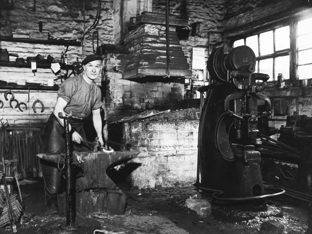 Laisterdyke blacksmith Joseph Gatenby, at work in his forge in March 1960. "I'm still learning after 50 years in the job," said Mr Gatenby. When he entered the profession in 1914 business was booming. Textile mills, breweries, tradesmen and the railways all used horses. Then, as motorised transport came increasingly into use, the number of horses began to wane until now Mr. Gatenby's customers are an odd mixture of rag and bone men, children with their ponies and the Bradford City Police mounted section.