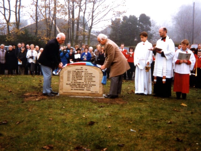 A dedication takes place of the memorial to the crew of the Halifax Bomber which crashed nearby this spot on Bradford Road in Tingley. The crash occurred on Thorpe Lane near the Bradford Road in West Ardsley on November 14, 1944 and it was witnessed by the 14 year-old Walter Townend, then a student at Morley Grammar School. The seven crewmen were all killed. Walter was determined to get a memorial put up for these men and this occurred in 1989 in the presence of some of the relatives of the dead airmen.