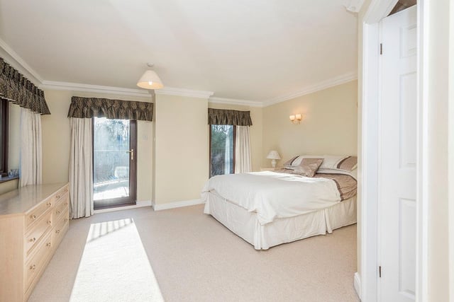 The main bedroom has a door to a large balcony, with an option for sitting or dining outside in the warmer months.