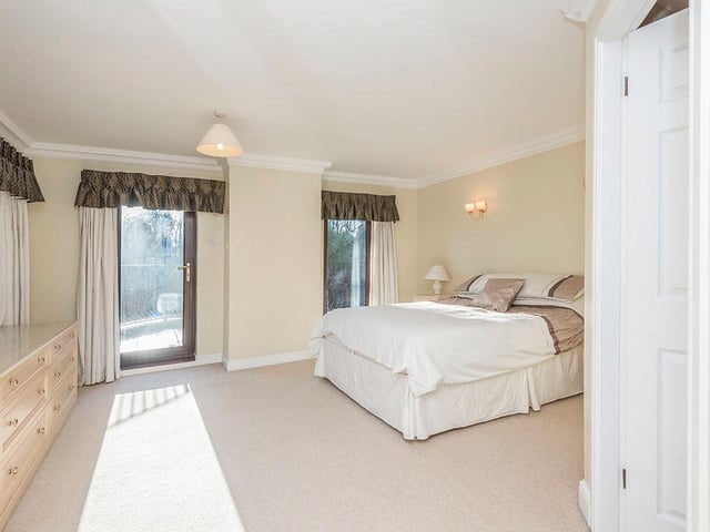 The main bedroom has a door to a large balcony, with an option for sitting or dining outside in the warmer months.