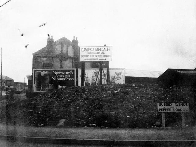 Hunslet's Sussex Avenue showing Davies and Metcalfe (Equipment) Ltd, described as 'engineers to the worlds railways' on a sign which points to the entrance to the right. Advertising hoardings can be seen, including one for Carlsberg lager. Pictured in March 1980.
