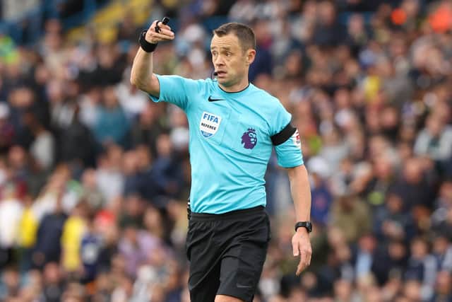 English referee Stuart Attwell gestures during the English Premier League football match between Leeds United and Aston Villa at Elland Road (Photo by NIGEL RODDIS/AFP via Getty Images)