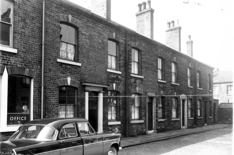 A Ford Zodiac Car is parked outside Lovington Street, part of the premises of J.F.White, manufacturing chemist, in May 1959.