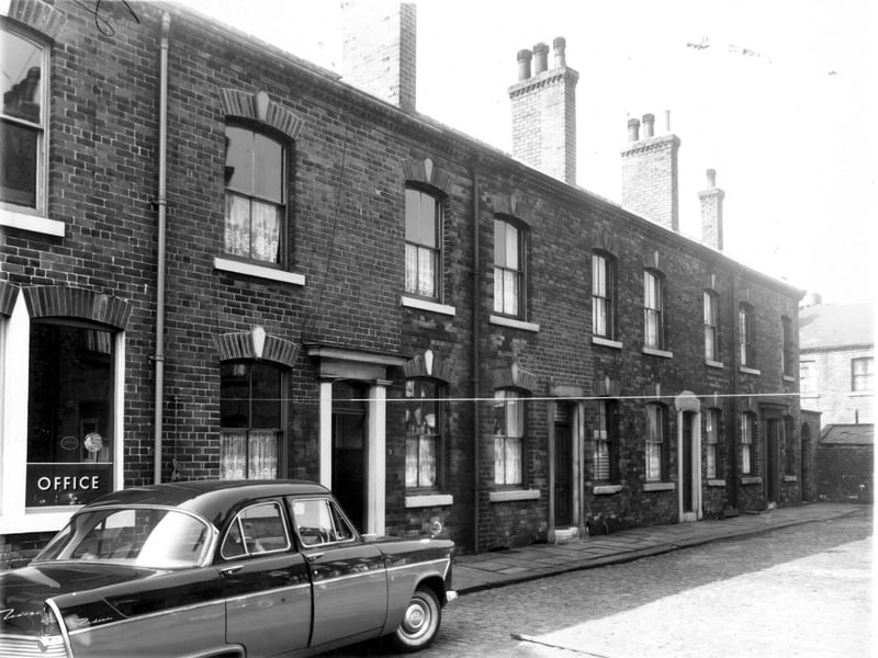 A Ford Zodiac Car is parked outside Lovington Street, part of the premises of J.F.White, manufacturing chemist, in May 1959.