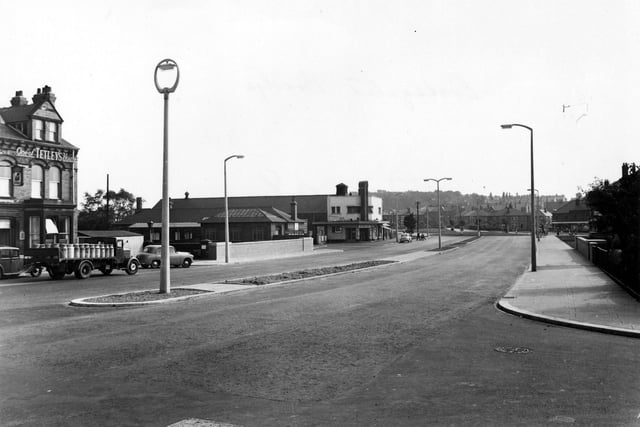 Completed bridge on Station Road. Station Hotel and Tetley pub on left, lorry parked full of beer barrels. Crossgates station and Ritz Cinema. Pictured in September 1955.