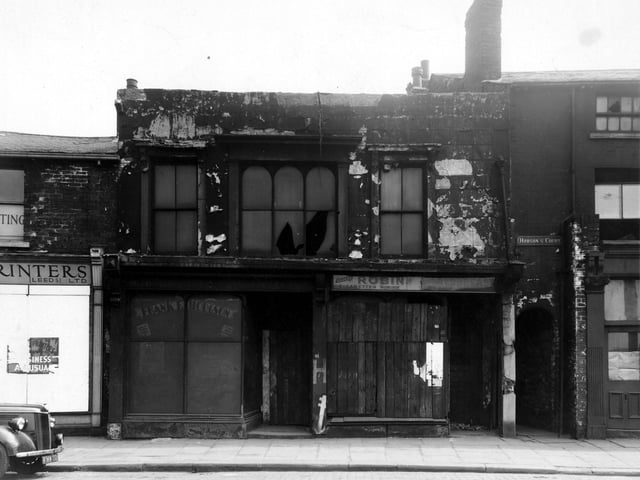Shops on Meadow Road in the city centre pictured in July 1947 plus Hobsons Court. Mann's Printers (Leeds) Ltd. on left.