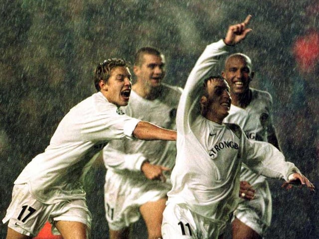 Lee Bowyer and teammates celebrate under a torrential downpour as Leeds defeat Milan at Elland Road. (Picture Credit: Laurence Griffiths/ALLSPORT)