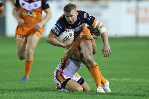 Tigers' Adam Milner is tackled by Arthur Mourgue during the win over Catalans. Picture by John Clifton/SWpix.com.