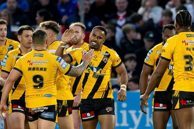 Jason Qareqare, facing camera, celebrates scoring for Castleford Tigers against Wakefield Trinity at Easter, but hasn't played since. Picture by Allan McKenzie/SWpix.com.
