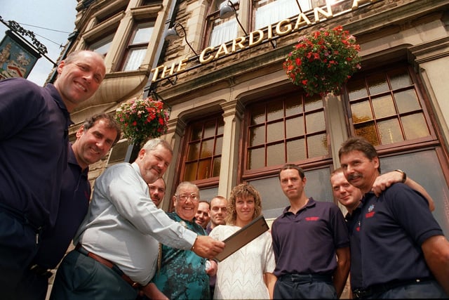 Mrs Majorie Farnsworth, centre, pictured outside the Cardigan Arms on Kirkstall Road, Leeds, with the landlord and landlady of the pub, Barrie and Janet Edmands, who rescued her from her blazing flat nearby. They have received bravery awards from West Yorkshire Fire Service, also pictured are firemen from Leeds Fire Station on Kirkstall Road, Leeds.