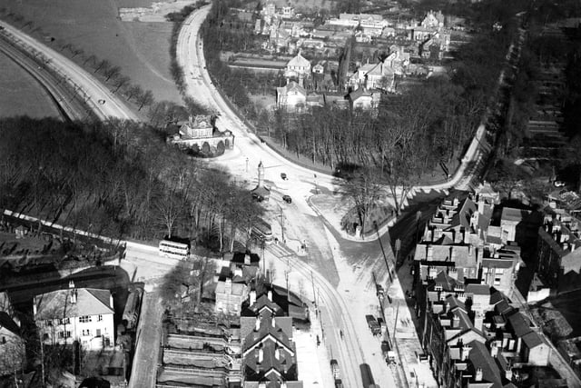 An aerial view from February 1937 centred on Oakwood Clock at the junction of, clockwise from centre left, Gledhow Lane, Prince's Avenue, Park Avenue, Wetherby Road and Roundhay Road. Trams and a bus can be seen on the roads.
