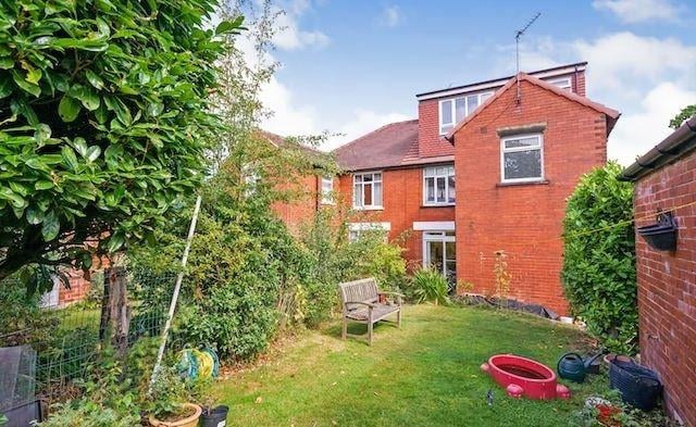 The property features a mature garden to the front and a driveway leading to the detached garage with an enclosed mature garden to the rear with patio area.