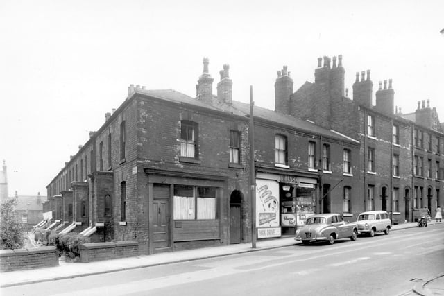 One side of St. Michaels Square can be seen on the left, this was numbers 10 through to 16. At 87 Chapeltown Road is the business of Philip Umanski, a gentleman's hairdresser. Pictured in July 1958.