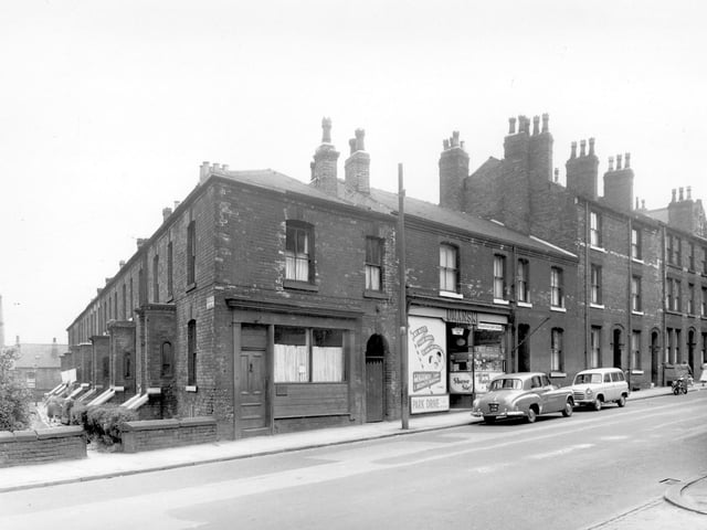 One side of St. Michaels Square can be seen on the left, this was numbers 10 through to 16. At 87 Chapeltown Road is the business of Philip Umanski, a gentleman's hairdresser. Pictured in July 1958.