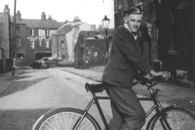 This is Robert H. Stead at the age of 14 taken from the bottom of Institution Street looking towards Woodhouse Street in 1947. In Woodhouse Street Holborn Garage can be seen and to the left is Wigley's printers. The rendered gable at the bottom right of Institution Street is number 9. On March 14 and 15, 1941, the building suffered an air-raid killing the occupants, a young family of three. Higher up, on the right, the single storey building was a plumbers, Arrowsmith's, and opposite a building which, in the late 1930s, housed a billiard hall on the first floor and held dances on the lower floor. In 1947 the billiard hall was managed by Mrs. Ellen Adamson Phillis. It was later to become a clothing factory.