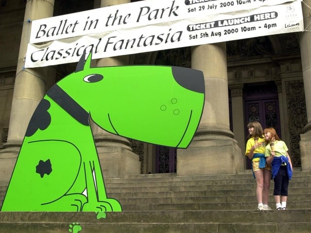 Emma Lowde, left, and sister Sophie from Walton near Wetherby, meet Geoffrey, the 12 foot green dog who was the mascot of Leeds Leisure Services, while queuing for the first tickets for the free Classical Fantasia tickets in 2000.