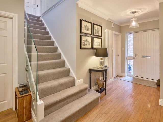 The glazed front door opens into a bright and welcoming entrance hall, where there is solid wood flooring, an open staircase and column radiators.