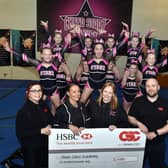 Cheerleaders receive the funding from CSG Regional Business Manager, Craig Dufferwiel