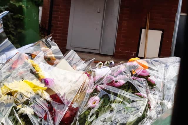 Flowers, candles and notes paying tribute to the 10-year-old boy have been left outside of the property in Holbeck, Leeds