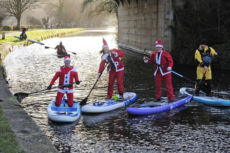 Santas line up on the canal. (pic by Steve Riding)