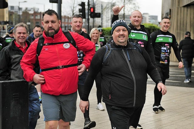 The walkers make their way up Eastgate, in Leeds.