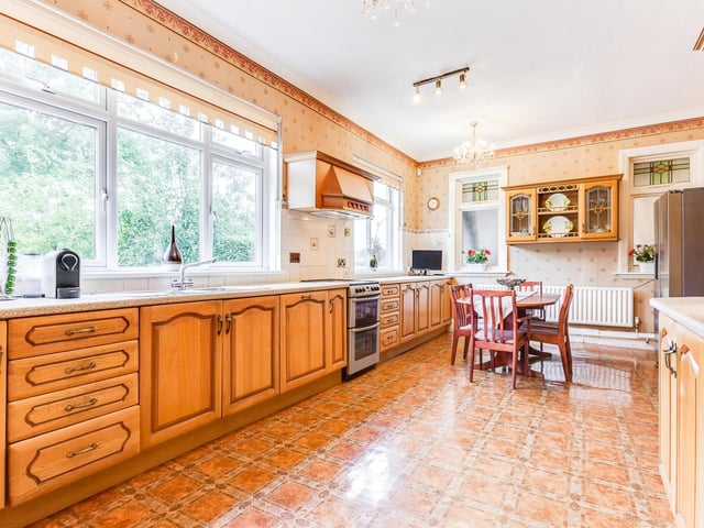 Fitted units and wide windows feature in this family dining kitchen.