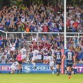 Wakefield fans and players celebrate during last season's shock home win over Wigan. Picture by Olly Hassell/SWpix.com.