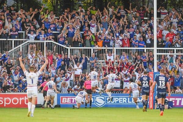 Wakefield fans and players celebrate during last season's shock home win over Wigan. Picture by Olly Hassell/SWpix.com.