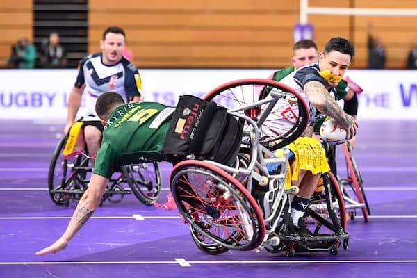 Huge collisions are common in wheelchair RL. Australia's Cory Cannane takes a tumble trying to tackle Lewis King of England. Picture by Will Palmer/SWpix.com.