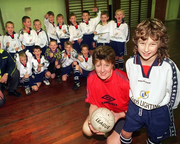 Angela Lunn, manager of Gildersome Spurs U-9s football team with first team captain Andrew Slater wearing the new kit presented to them by Dennis Cook (pictured) of Rawcliffe's in the city centre after their old strip was stolen. Pictured in December 1997.