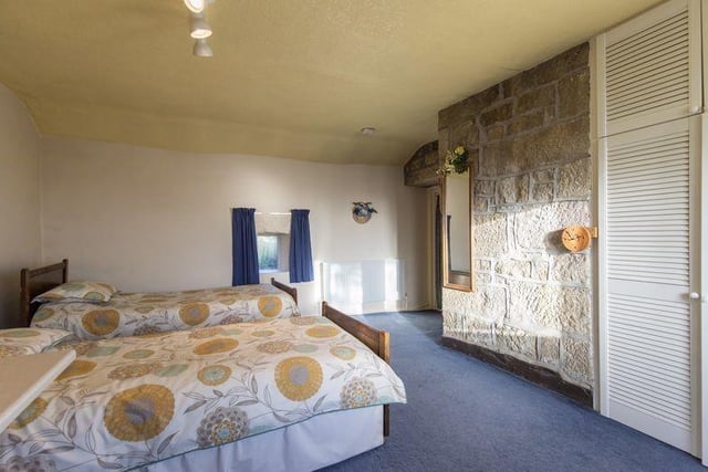 Bedrooms are spacious - this one has a feature exposed stone wall.