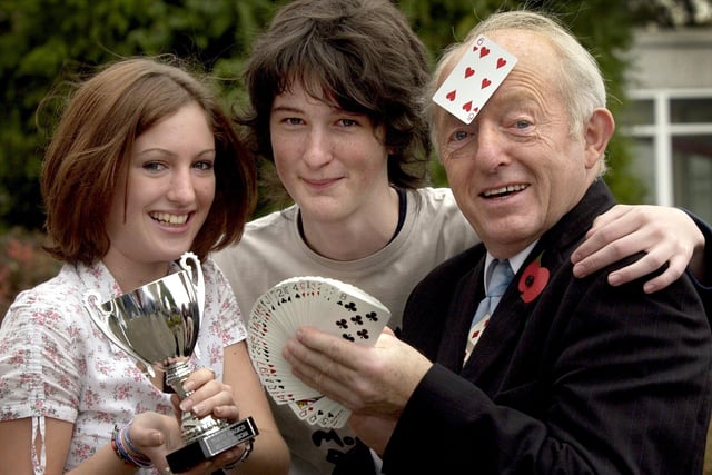 Teenage magic enthusiasts Holly Bedford and Alasdair Dinnewell show their gratitude to world-famous magician Paul Daniels, presenting him with a special award during his visit to Boston Spa Comprehensive School.