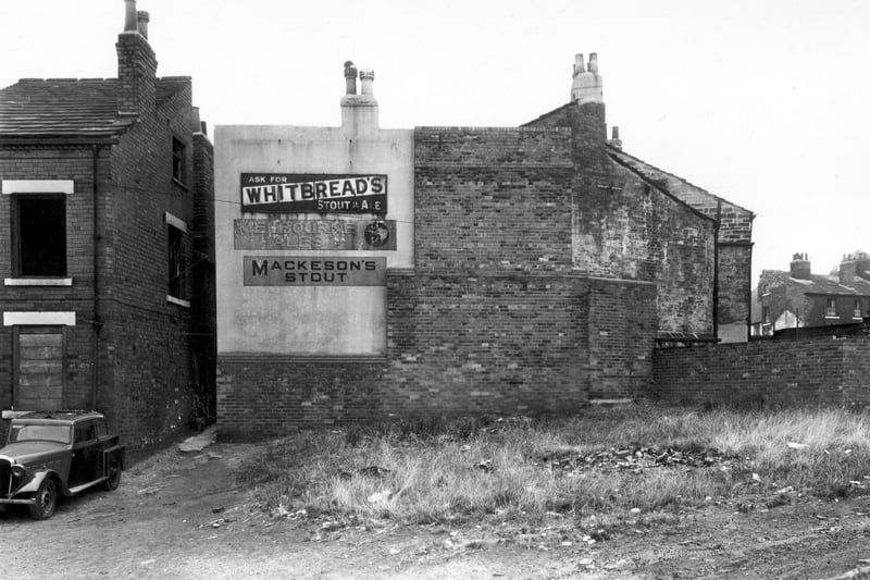 On the left is one of a row of three houses which which lay back-to-back with 10 to 14 Ebury Street. Access was from Delph Street. This end house was no.3 seen from Woodhouse Cliff end. The building with advertisements on he wall is 21 Woodhouse Cliff, seen here from the rear. It was a licensed grocer's shop. The area in the foreground was formerly White Rose Yard. Pictured in September 1959.