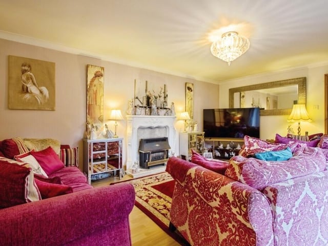 One of the reception rooms, with feature fireplace.