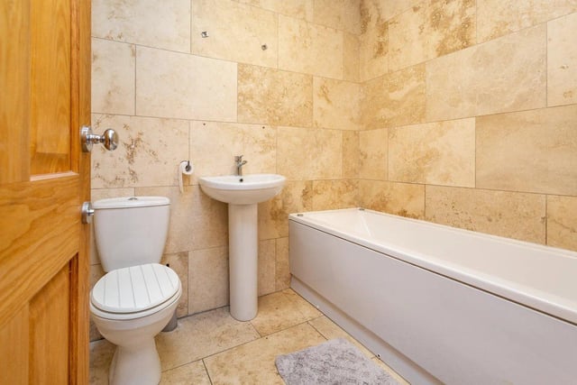 The family bathroom provides a jacuzzi style bath, hand basin and toilet.