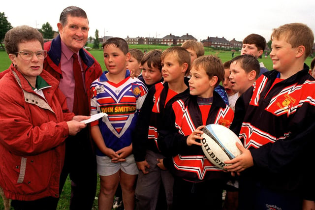 Colin and Una Cooper are pictured with young players at Hunslet Parkside Amateur RL in June 1997.