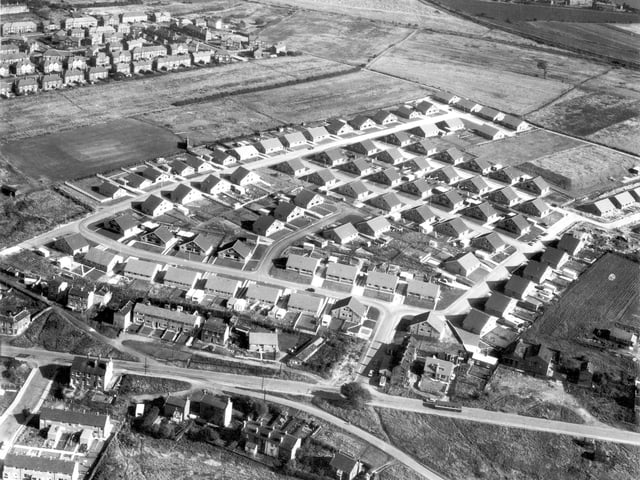 An undated view of new bungalow and chalet of Drighlington's Moorside estate, part of Fairfax council estate. Disused railway track and Leeds-Huddersfield Road in the background.