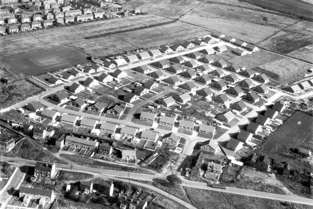An undated view of new bungalow and chalet of Drighlington's Moorside estate, part of Fairfax council estate. Disused railway track and Leeds-Huddersfield Road in the background.